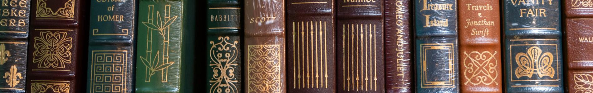 Book shelf, filled with a variety of books.