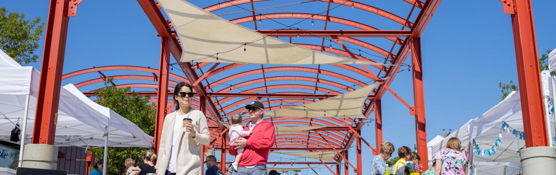 People shopping on the plaza space at the City City Market