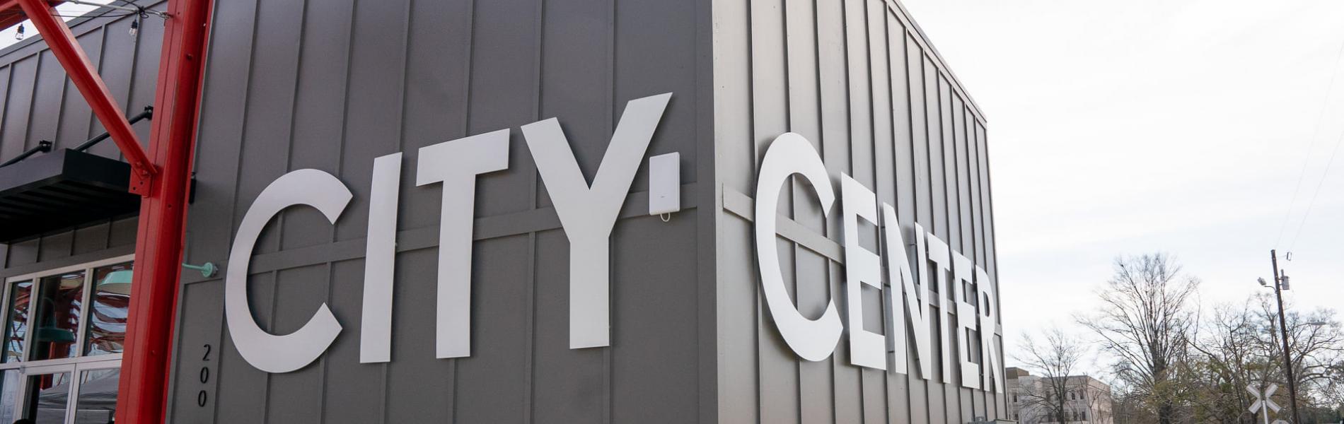Grey building with the words City Center on the sides in large, white letters.