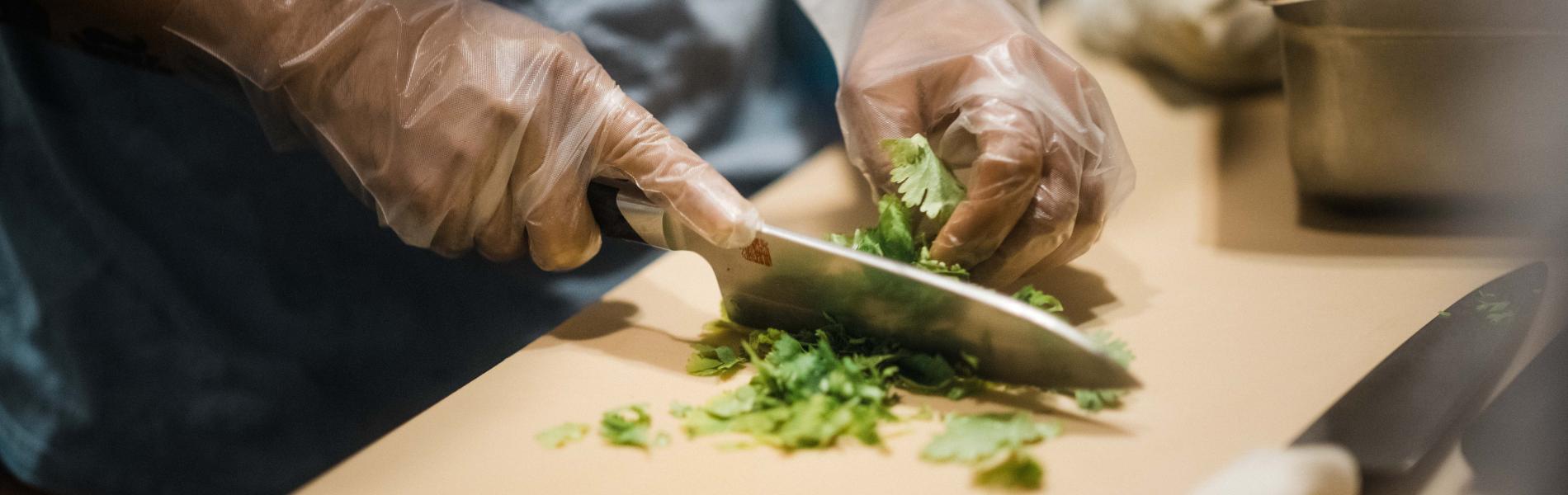 A man chopping vegetables with a knife